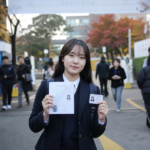 수능 시험장 입구에서 수험표와 신분증을 확인하는 수험생
